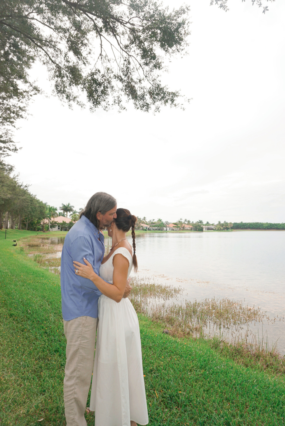 Patrick and Sarah embracing by the lake
